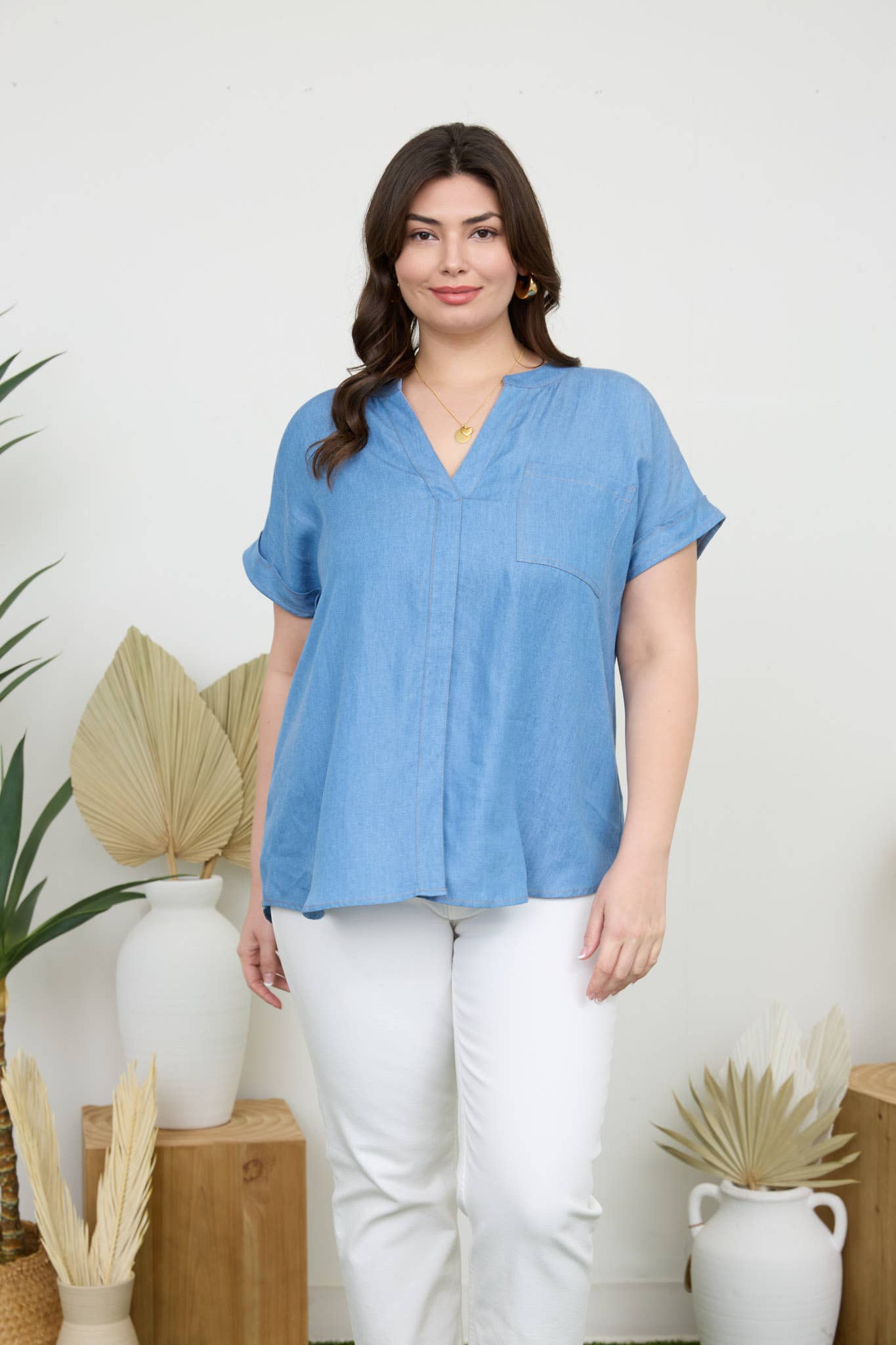 Stylish PLUS BACK BUTTON CUFF SLEEVE CHAMBRAY TOP with pocket detail and split hem, perfect for casual outfits.