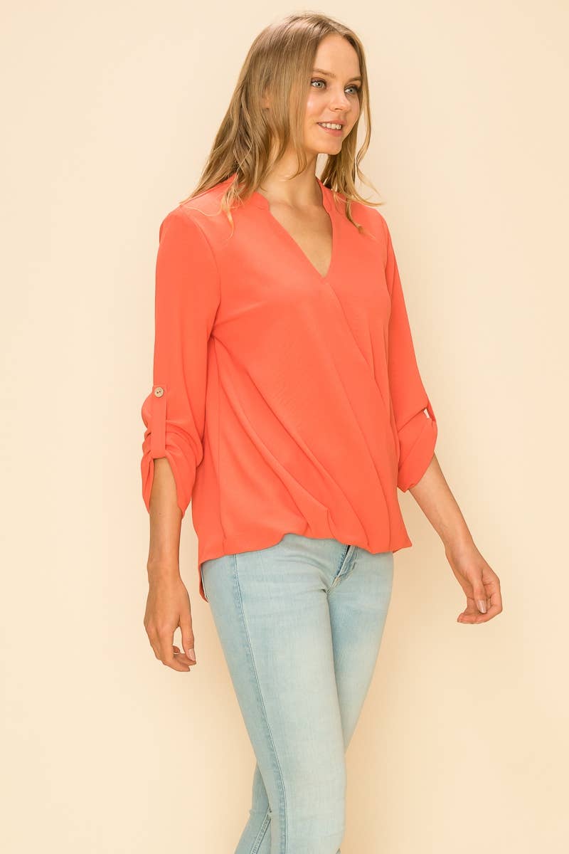 Stylishly showcase the WRAP COLLAR BLOUSE with its V-neck and asymmetrical hem for a sophisticated look.