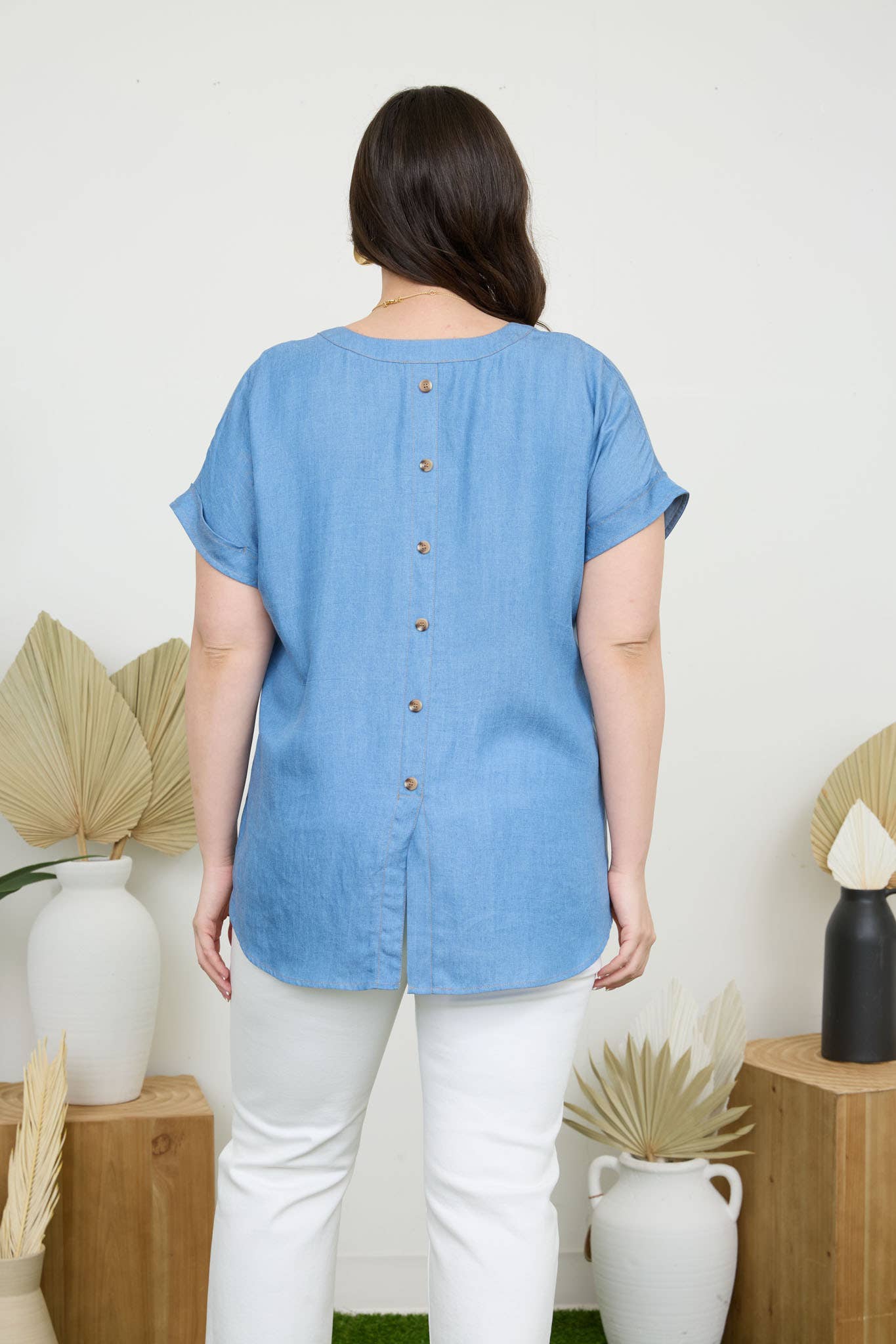 Stylish PLUS BACK BUTTON CUFF SLEEVE CHAMBRAY TOP featuring a split hem and pocket detail, perfect for any occasion.
