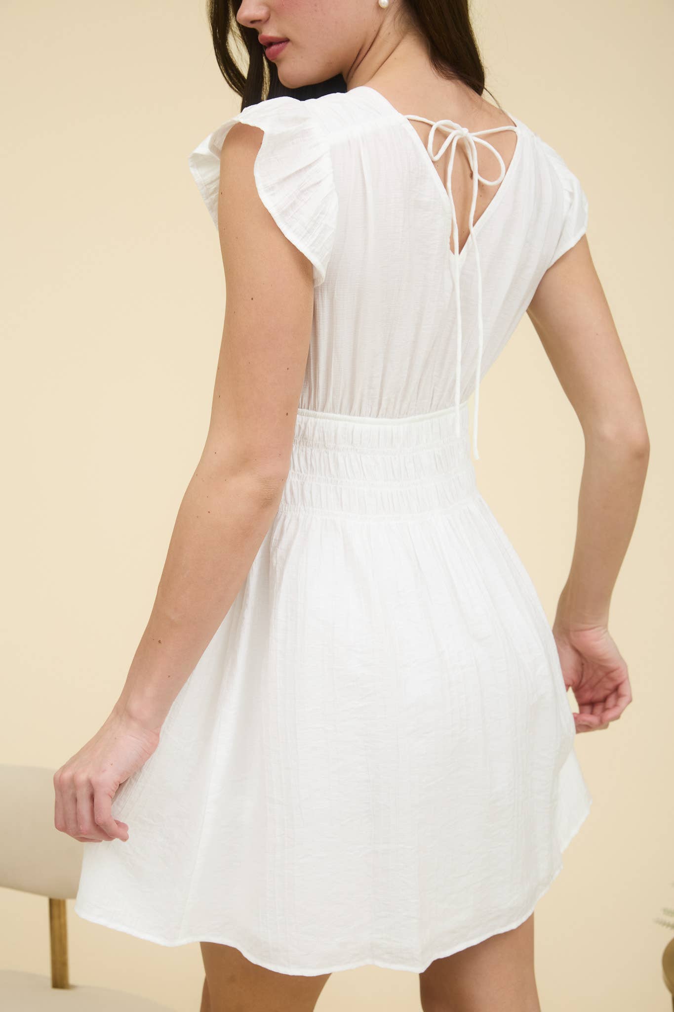 Stylish RUFFLE SLEEVE MINI DRESS featuring a V neckline and shirred elastic waist for a chic summer look.