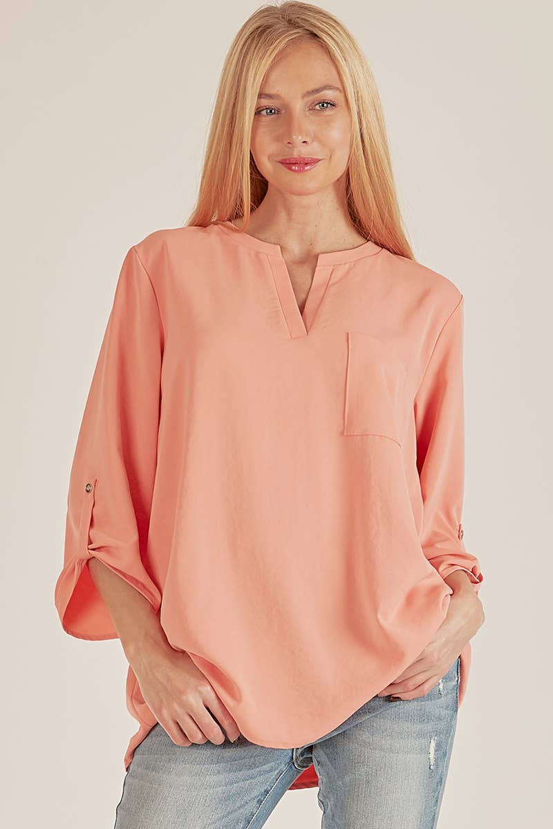 Stylish Pocket Blouse in soft coral, featuring a front pocket and loose fit, perfect for any occasion.