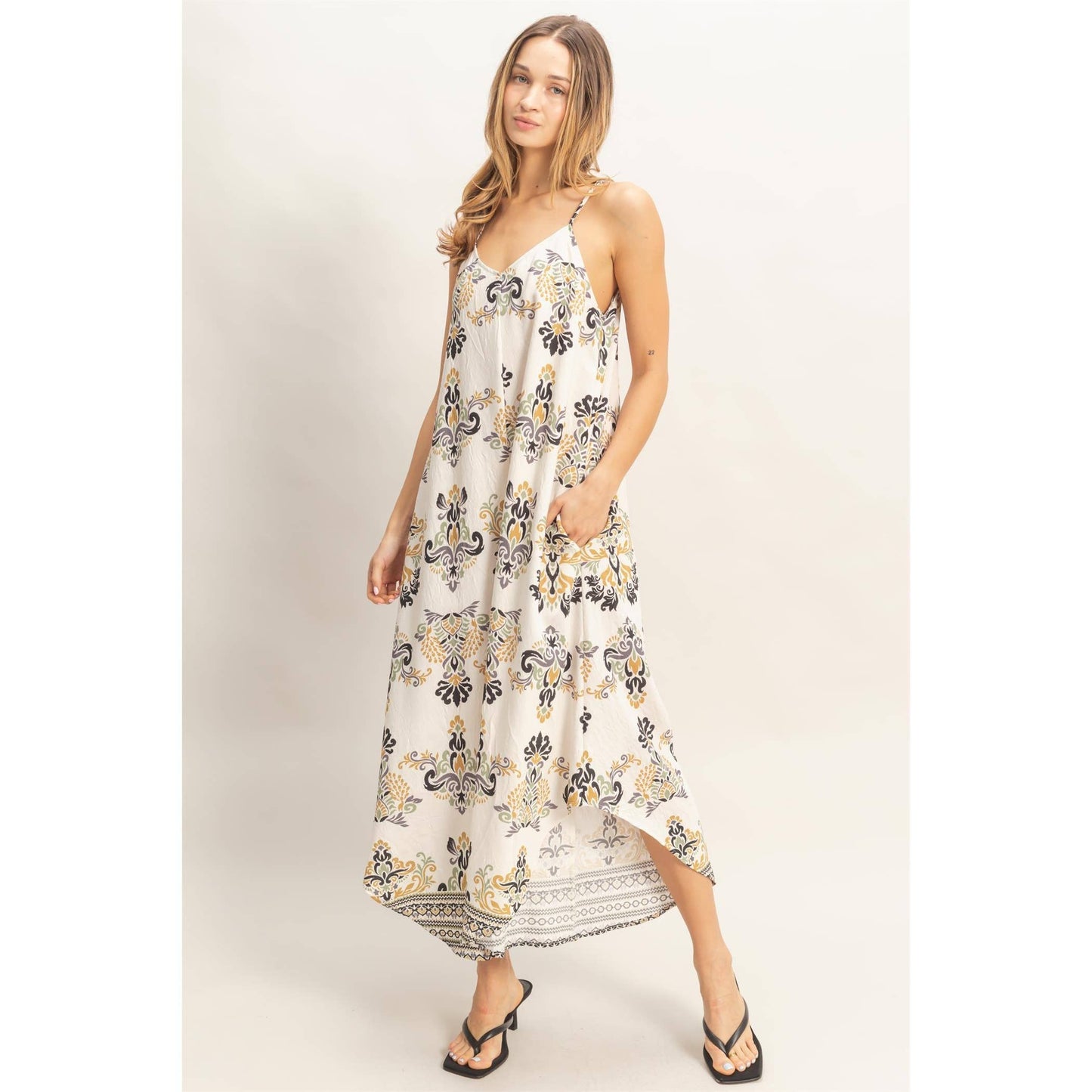Floral Print Spaghetti Jumpsuit on model, flowy with adjustable straps; size Small, worn with sandals.