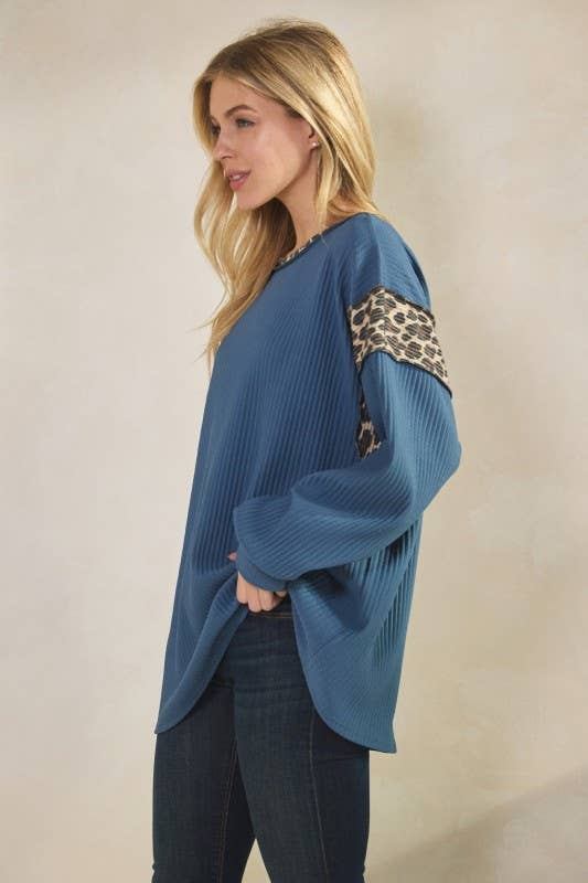 Blue long-sleeve Animal Contrast Top with leopard-print rib trim on shoulders, worn by model.