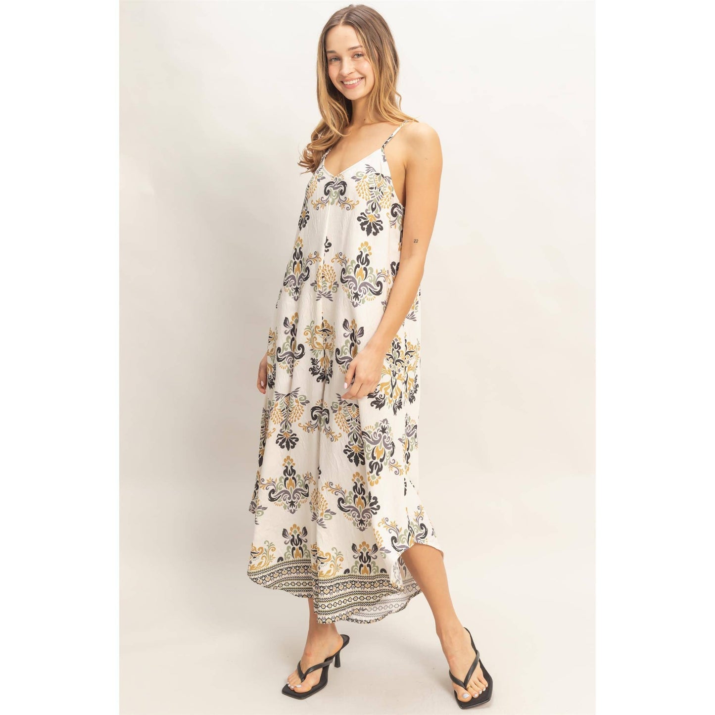 Floral Print Spaghetti Jumpsuit on a smiling model with adjustable straps and a flowy fit.