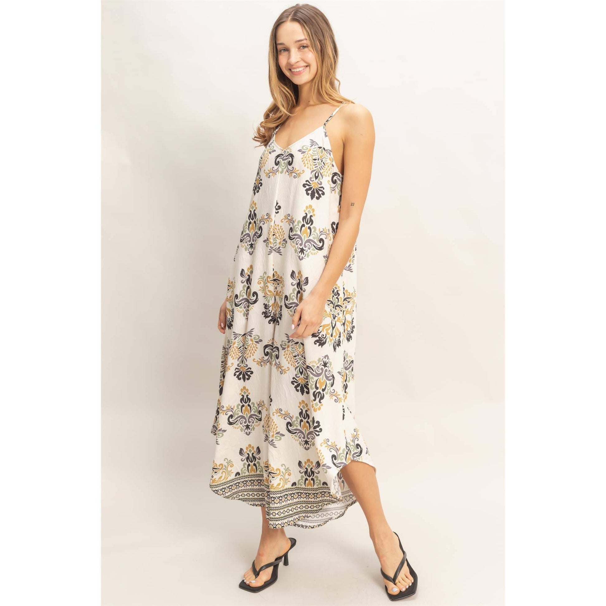 Floral Print Spaghetti Jumpsuit on a smiling model with adjustable straps and a flowy fit.