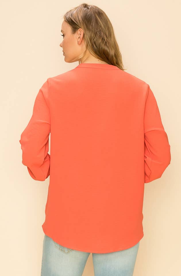 Stylish WRAP COLLAR BLOUSE in coral, featuring long sleeves and a faux wrap design for a sophisticated look.