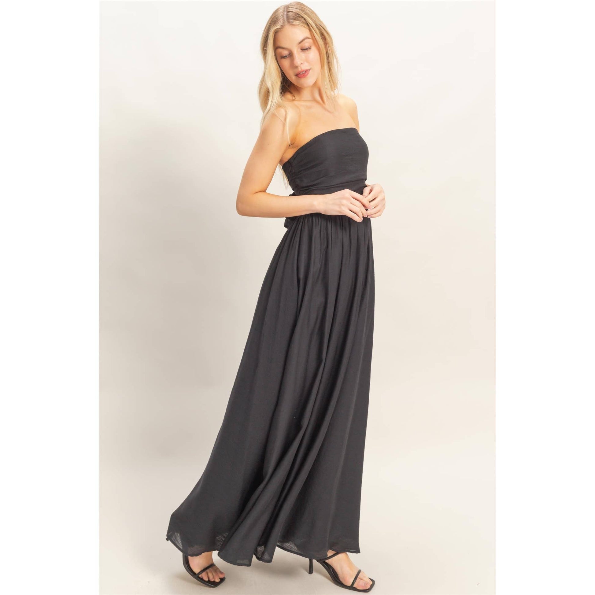 Strapless Tie-Back Smocked Dress on a model with a flowing black skirt.