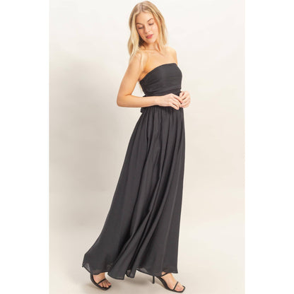 Strapless Tie-Back Smocked Dress on a model with a flowing black skirt.