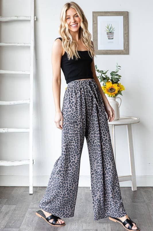 Wild Side Pants: leopard-print polyester-spandex wide-leg pants with elastic waist, drawstring, side pockets on a model.