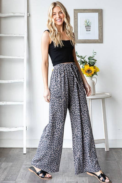 Wild Side Pants: leopard-print polyester-spandex wide-leg pants with elastic waist, drawstring, side pockets on a model.