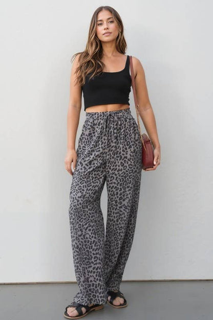Wild Side Pants: leopard print, elastic waist with drawstring, side pockets, relaxed wide-leg pants on model
