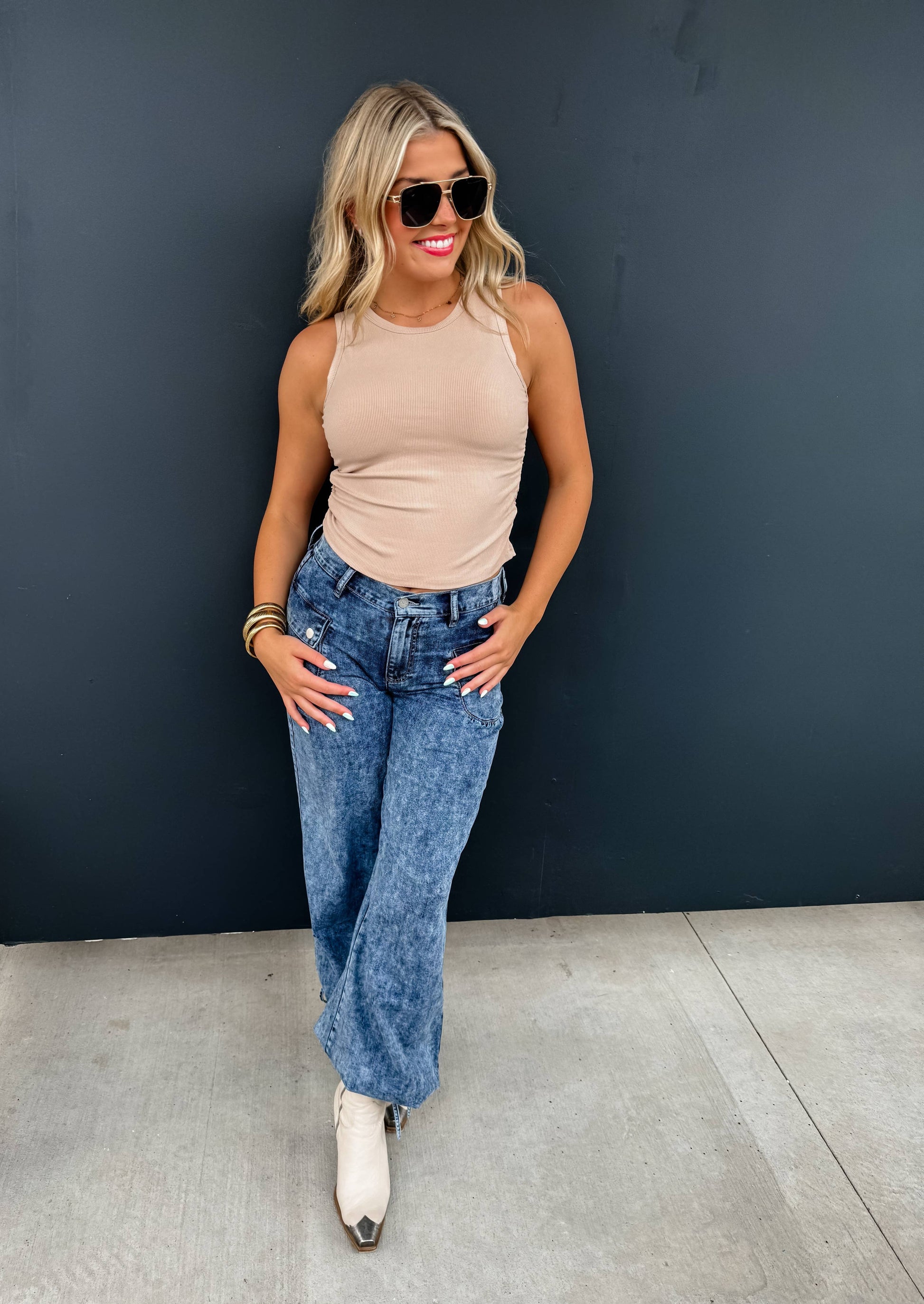 Woman wearing Charlie Cinch Hem Wide Leg Jeans in blue denim with elastic waist and front pockets.