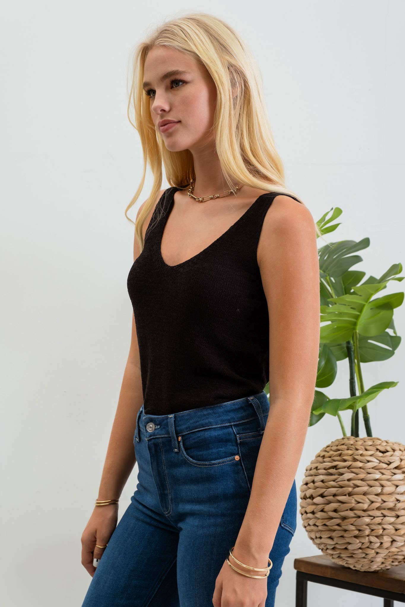 Solid black KNIT TANK TOP with scoop neckline, sleeveless, made of acrylic and nylon, from shop name.